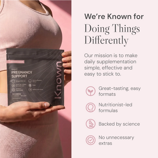 Person holding a Known pregnancy support supplement on a pink background